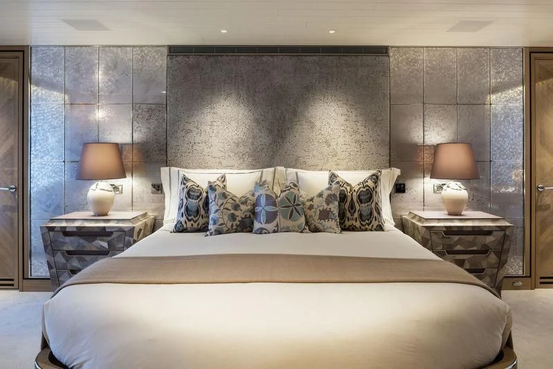 a bed with a white bed spread aboard JOY Yacht for Sale