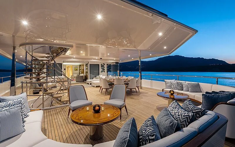 a living room with a large patio aboard JOY Yacht for Sale