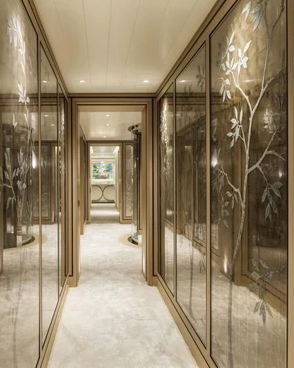 a hallway with glass walls aboard JOY Yacht for Sale