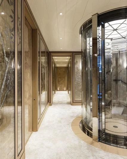 a hallway with glass doors aboard JOY Yacht for Sale