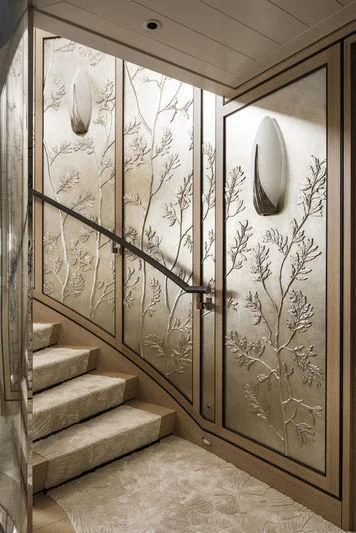 a staircase with a white wall aboard JOY Yacht for Sale