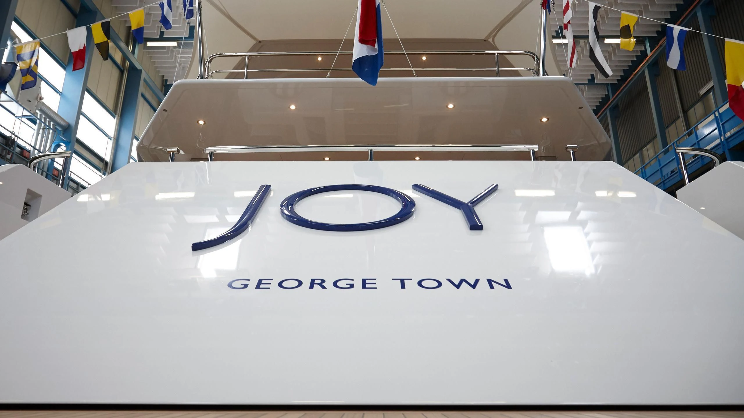 a white rectangular box with blue text on it aboard JOY Yacht for Sale
