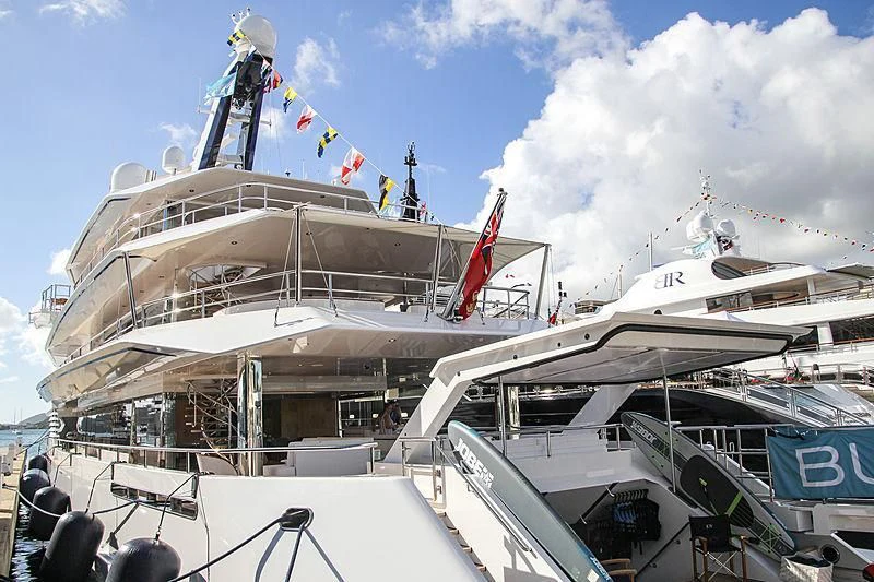 a large white boat with a crane on top aboard JOY Yacht for Sale