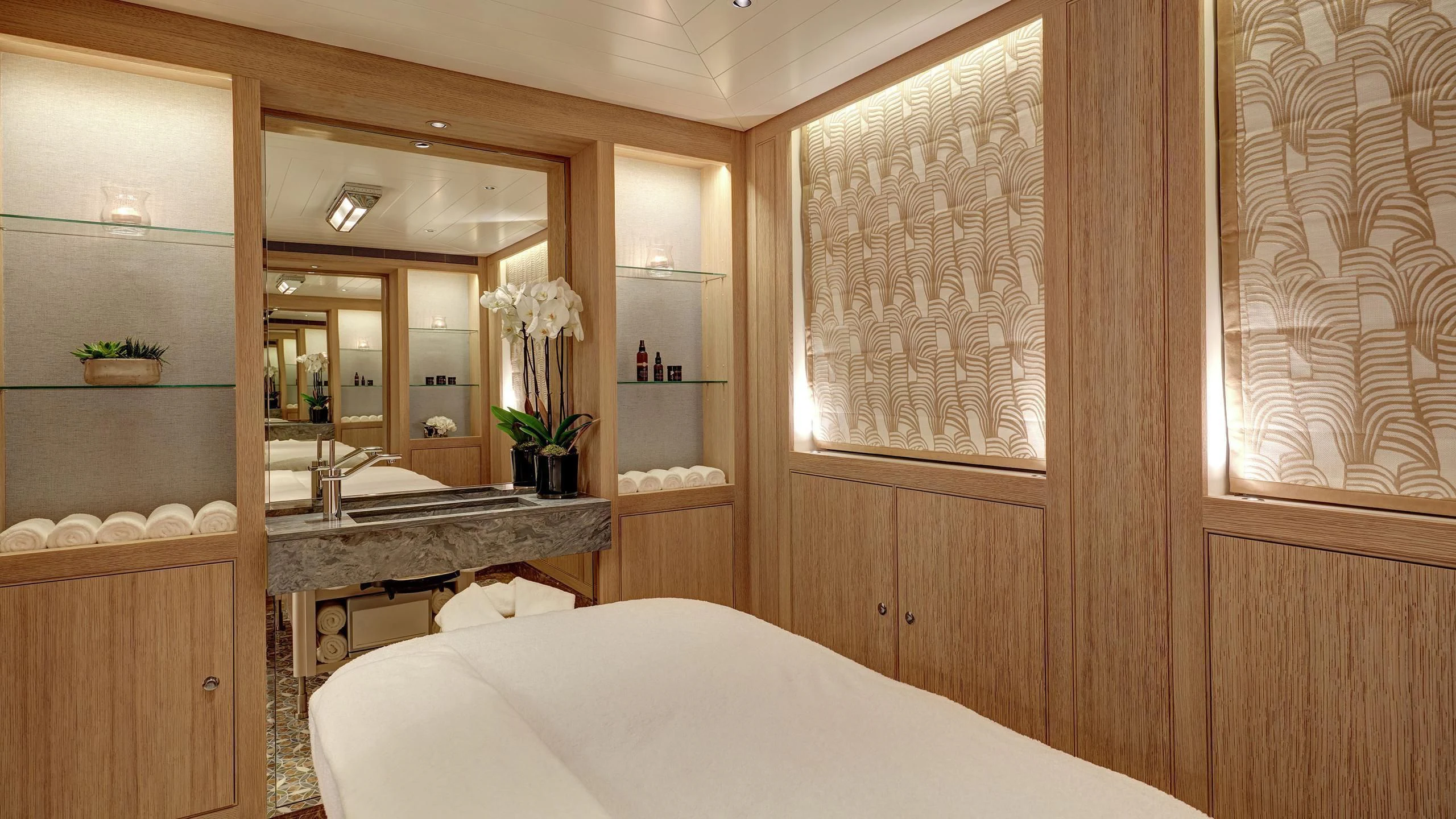 a room with a bed and a mirror aboard JOY Yacht for Sale