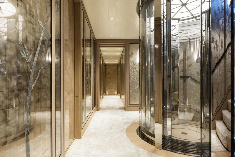 a room with glass walls and a large mirror aboard JOY Yacht for Sale