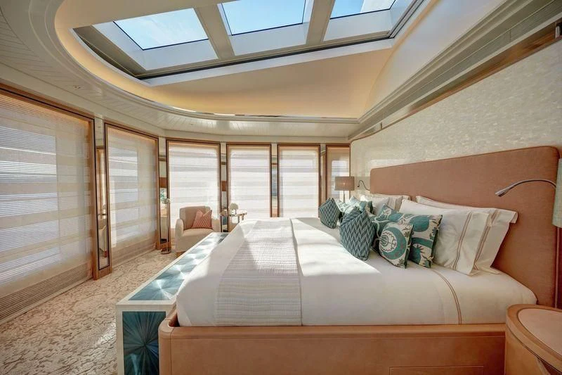 a large bedroom with a large bed aboard JOY Yacht for Sale