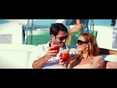 a man and woman holding drinks aboard JOY Yacht for Sale