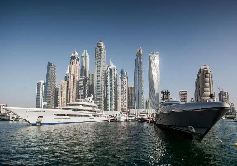 a boat in the water with a city in the background aboard JOY Yacht for Sale