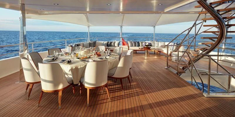 a room with a table and chairs aboard JOY Yacht for Sale