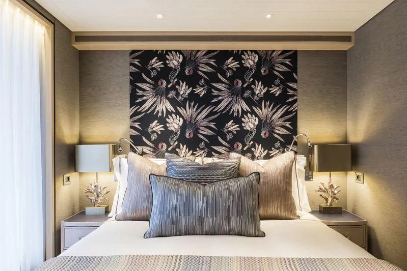 a bed with a blue pillow aboard JOY Yacht for Sale