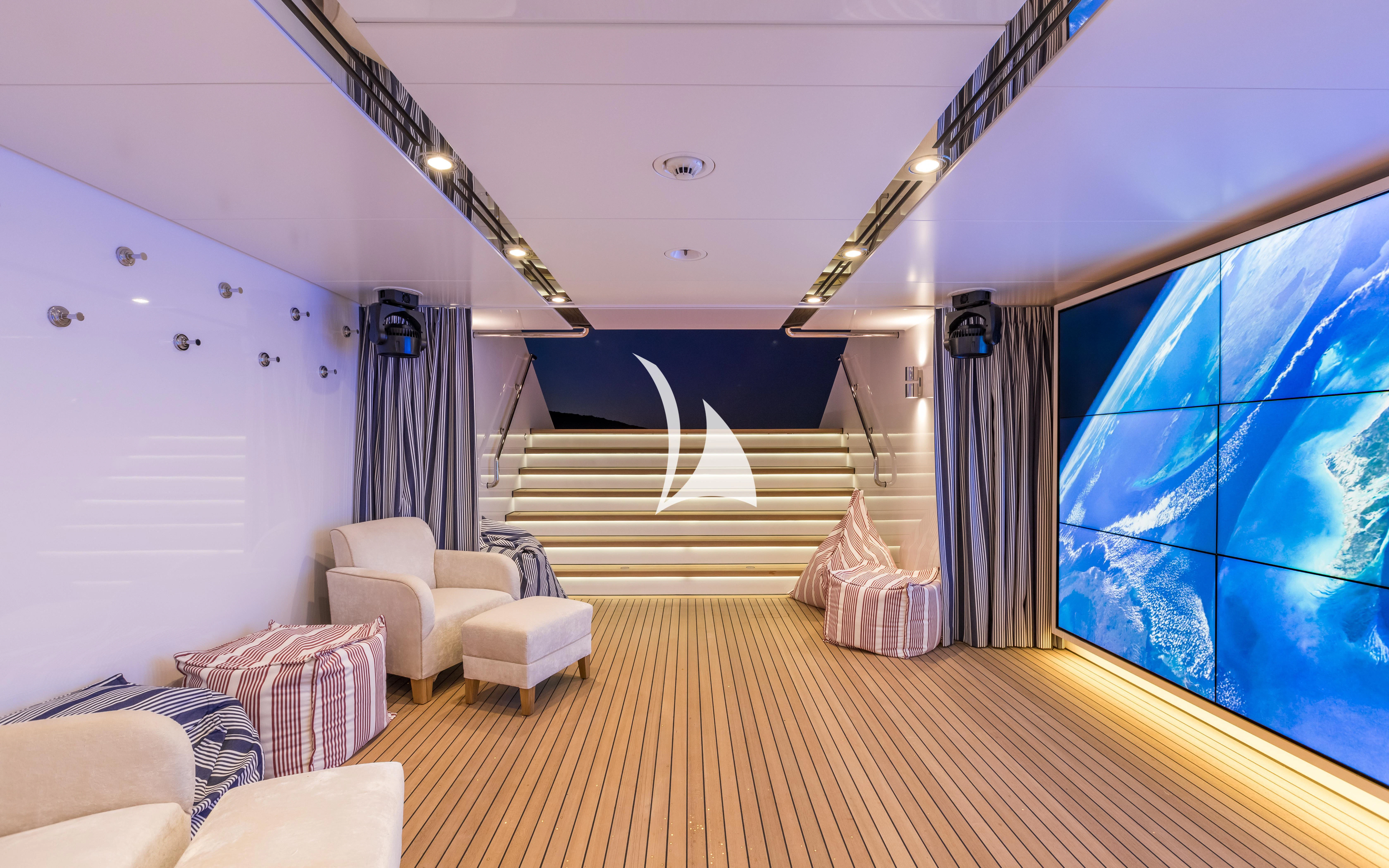 a room with a staircase and a large window aboard JOY Yacht for Sale