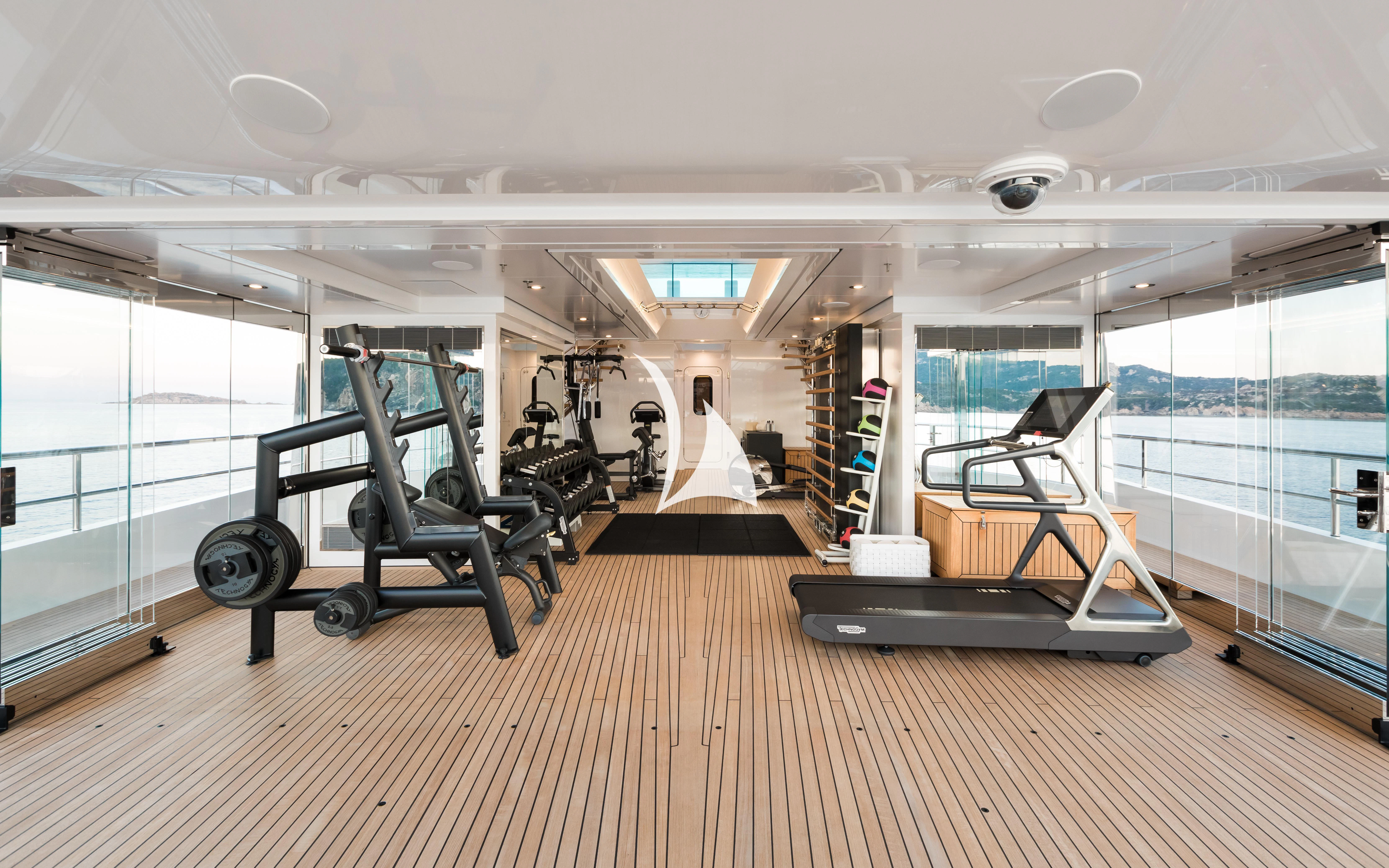 a room with a cart and a large window aboard JOY Yacht for Sale