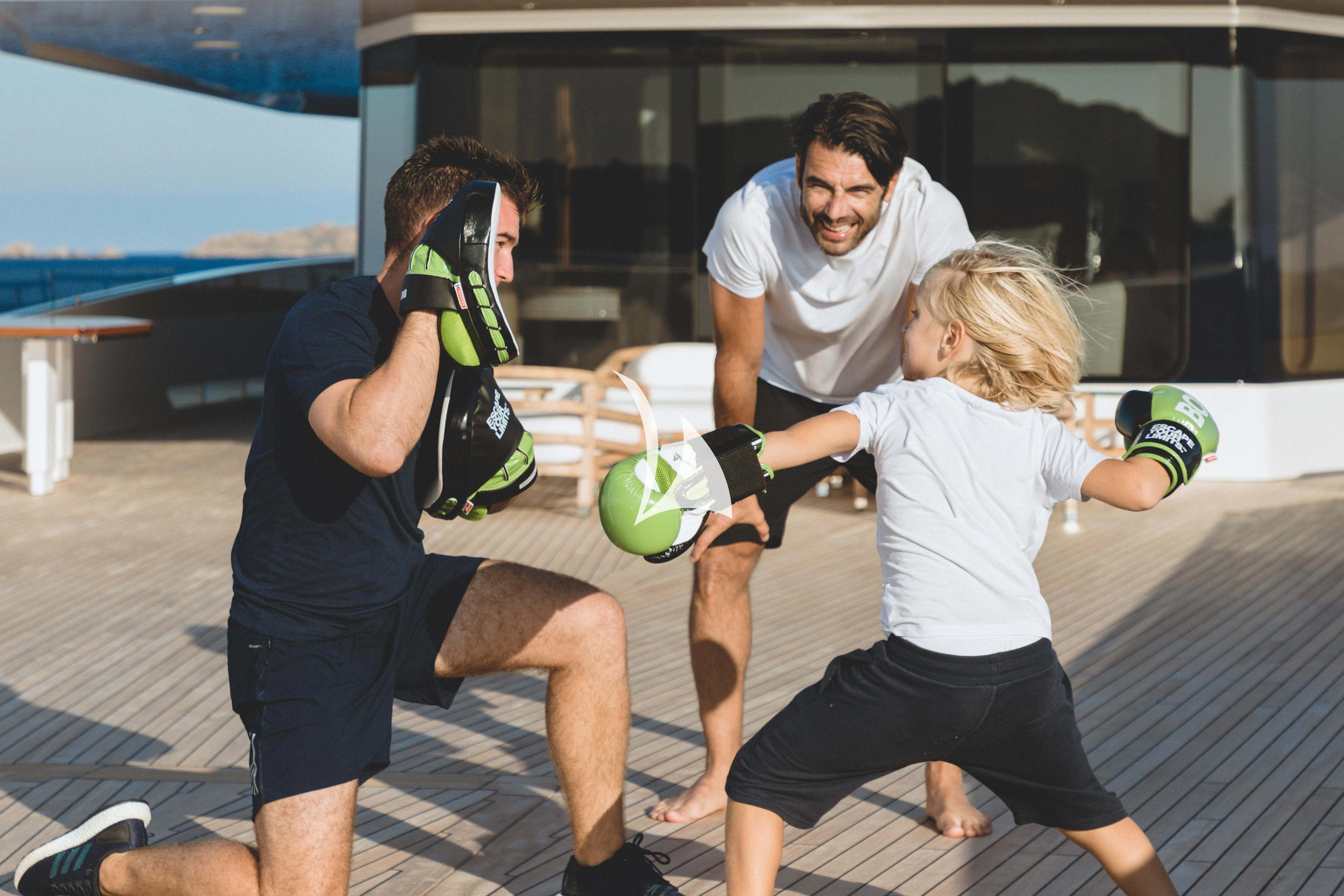 a group of people on a deck aboard JOY Yacht for Sale