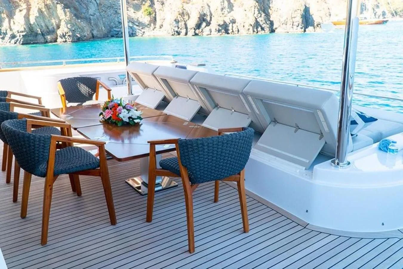 a table and chairs on a deck aboard CUSTOM LINE  97 Yacht for Sale