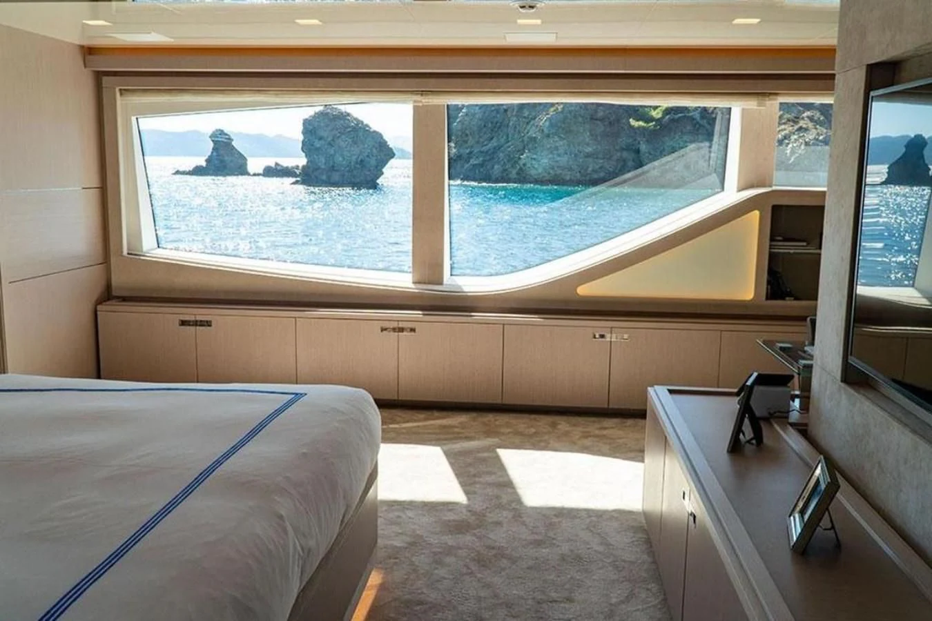 a room with a large window and a bed aboard CUSTOM LINE  97 Yacht for Sale