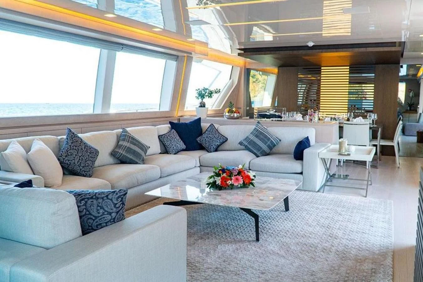a living room with a couch and a table aboard CUSTOM LINE  97 Yacht for Sale