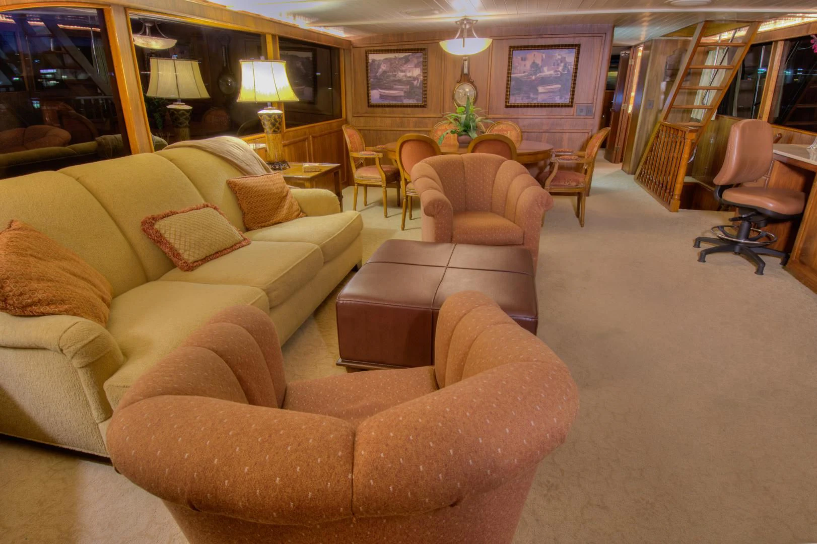 a living room with couches and chairs aboard WHISKEY DAWN Yacht for Sale