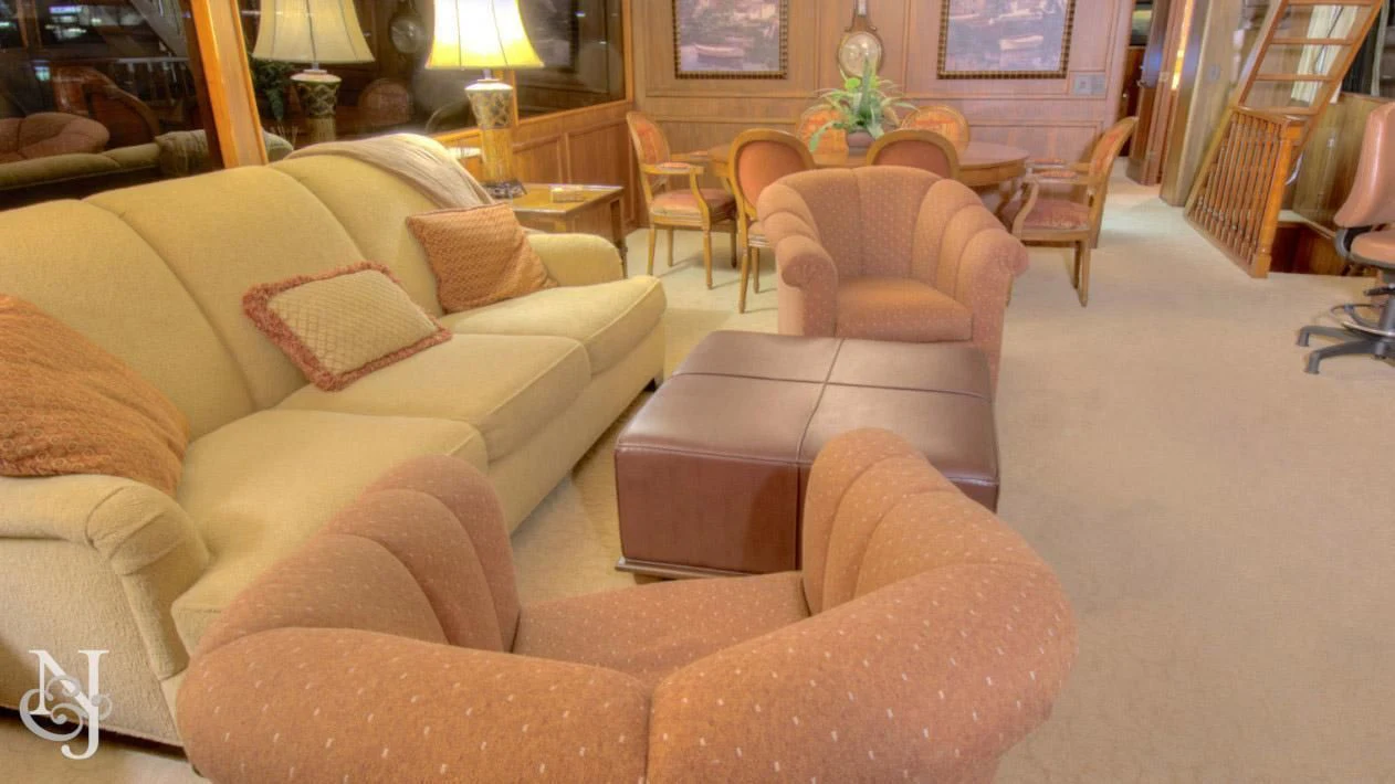 a living room with a couch and chairs aboard WHISKEY DAWN Yacht for Sale