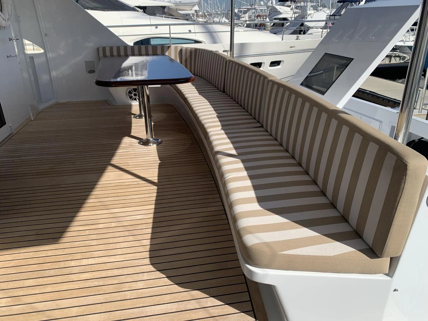 a white staircase with a table and umbrella aboard WHISKEY DAWN Yacht for Sale