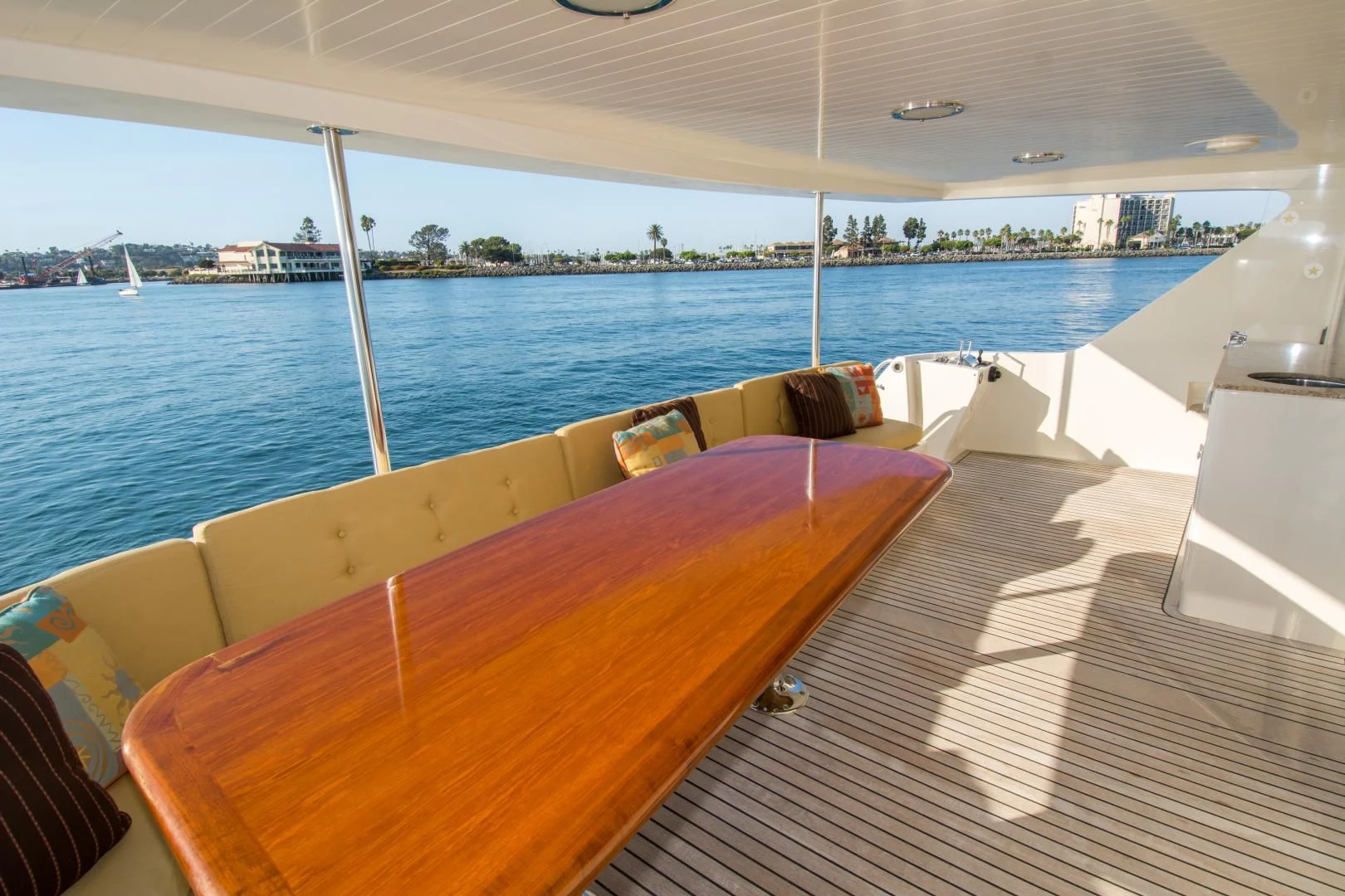 a deck with a view of a city and water aboard WHISKEY DAWN Yacht for Sale