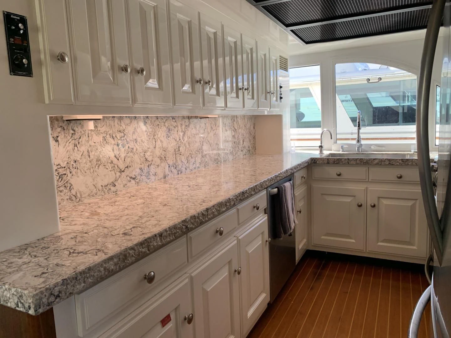 a kitchen with white cabinets aboard WHISKEY DAWN Yacht for Sale