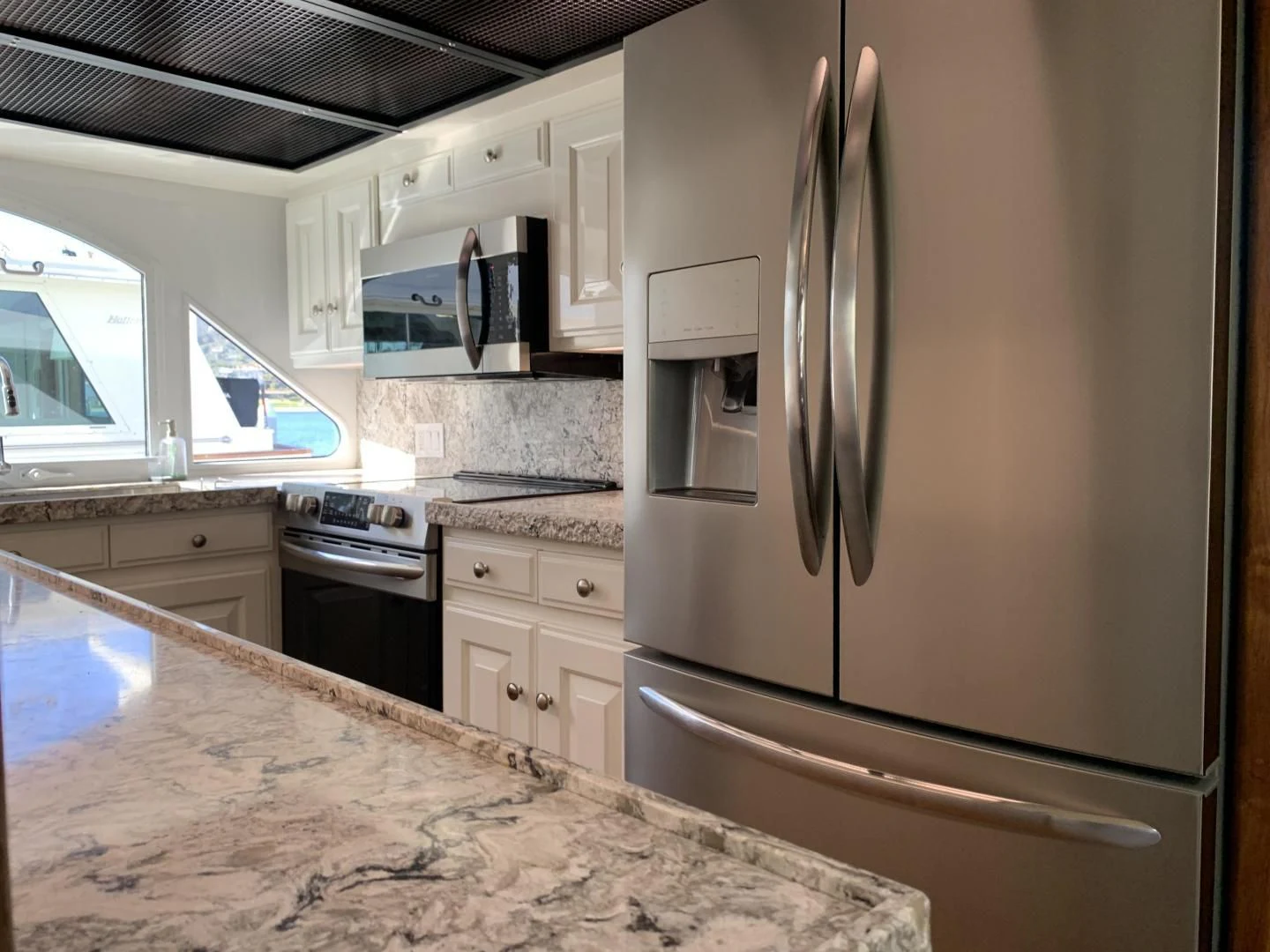 a kitchen with a stainless steel refrigerator aboard WHISKEY DAWN Yacht for Sale