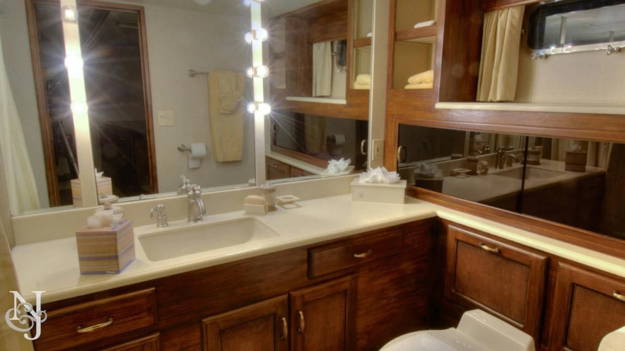 a bathroom with a large mirror aboard WHISKEY DAWN Yacht for Sale