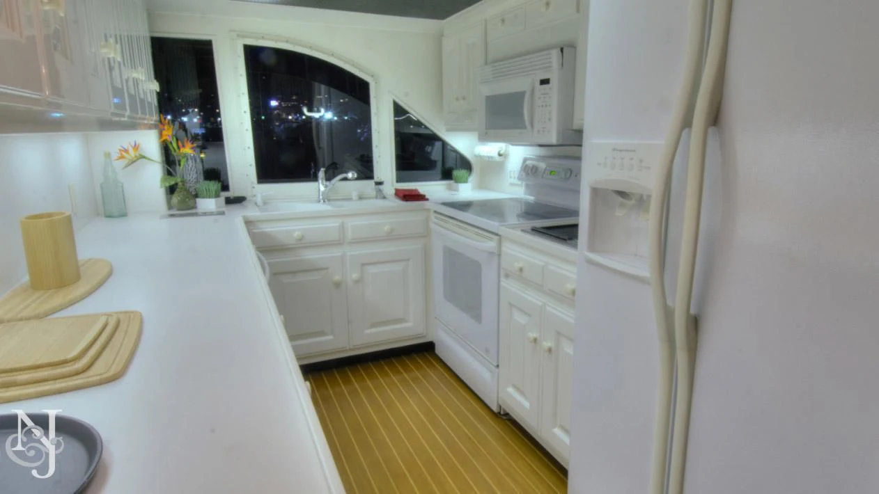 a kitchen with white cabinets aboard WHISKEY DAWN Yacht for Sale