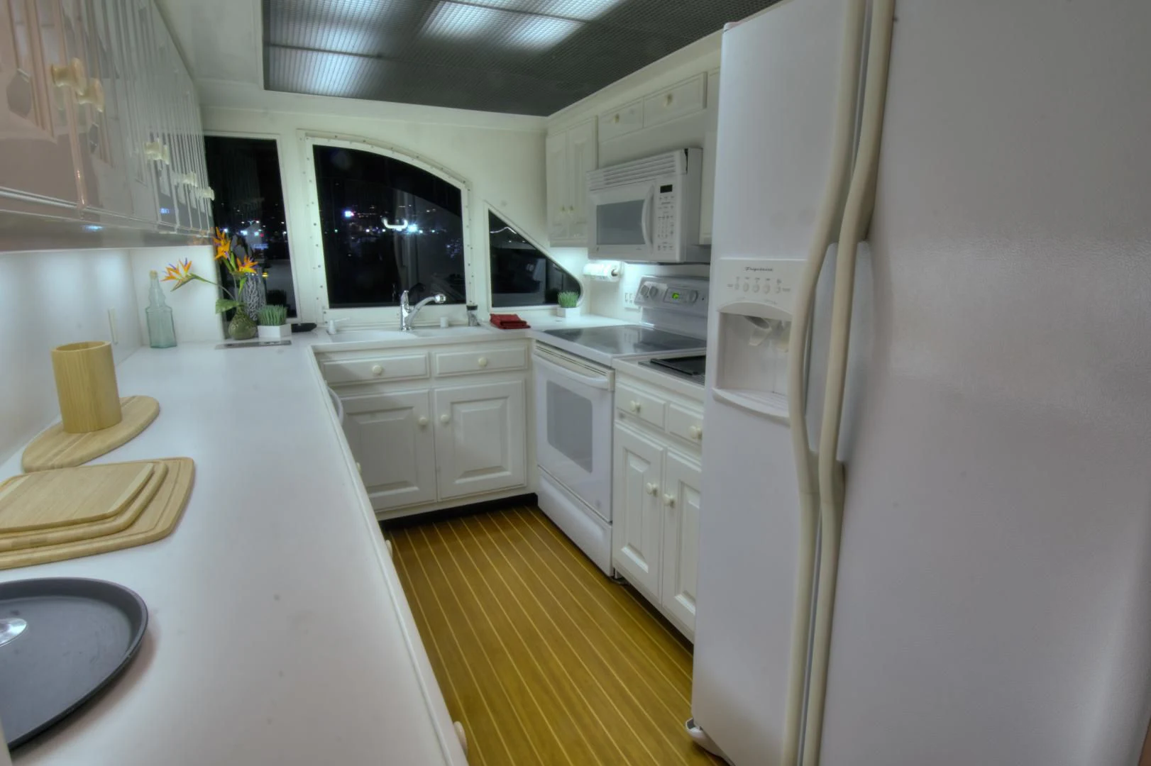 a kitchen with white cabinets aboard WHISKEY DAWN Yacht for Sale