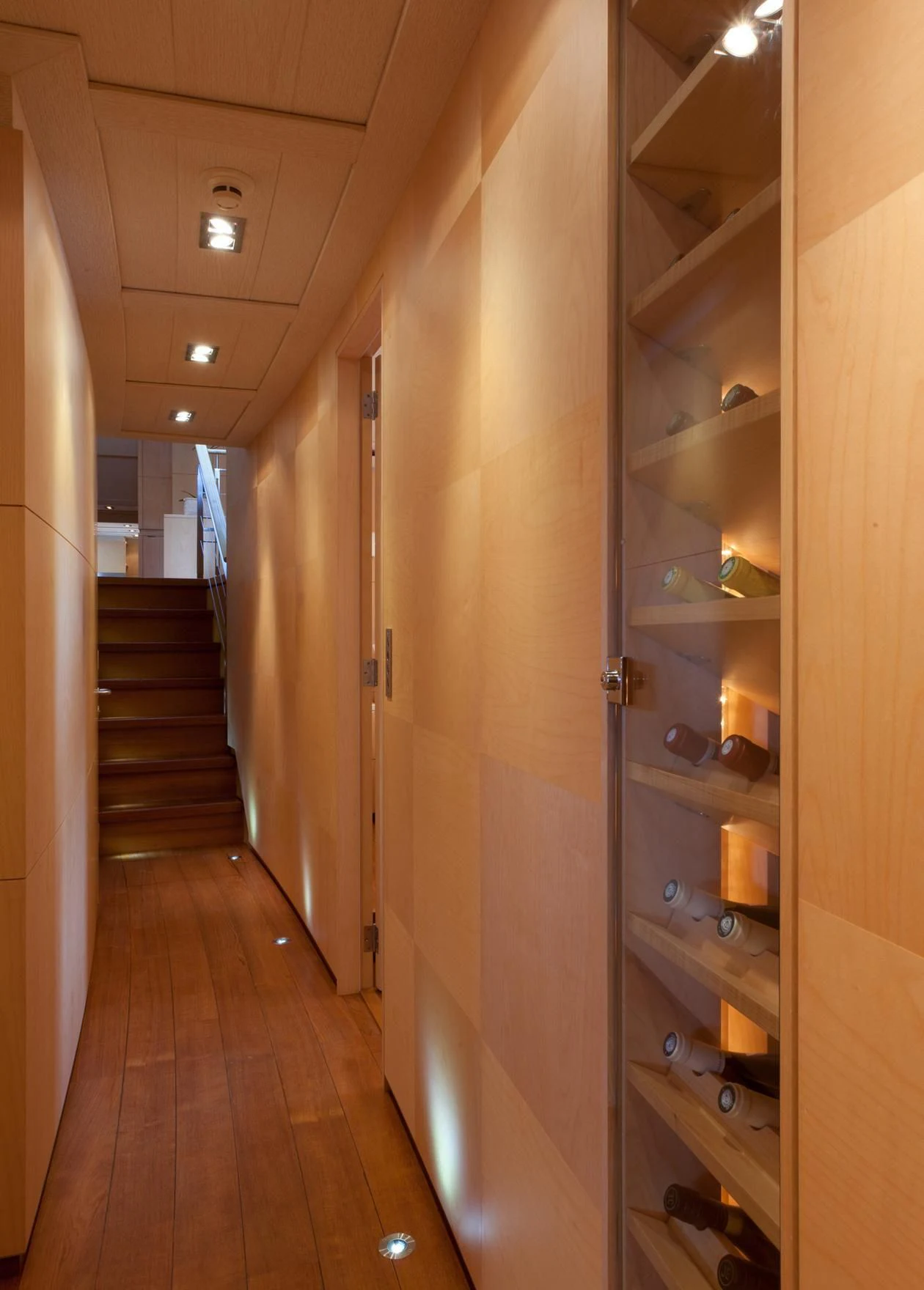 a hallway with a door and a staircase aboard GUILLEMOT Yacht for Sale