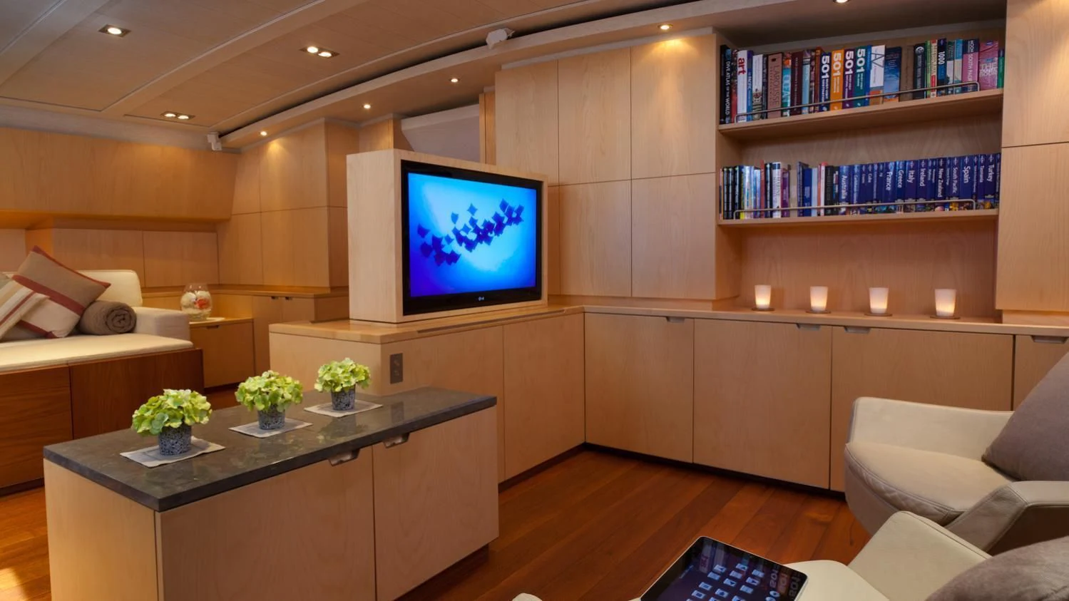 a room with a tv and a table aboard GUILLEMOT Yacht for Sale