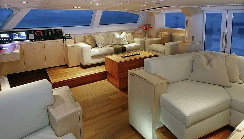 a living room with a couch and a coffee table aboard GUILLEMOT Yacht for Sale