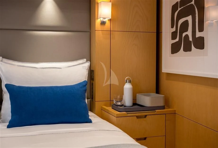 a room with a bed and a lamp aboard GUILLEMOT Yacht for Sale