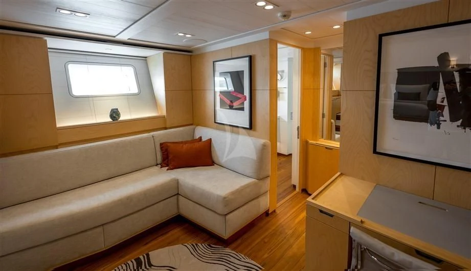 a living room with a couch and a table aboard GUILLEMOT Yacht for Sale