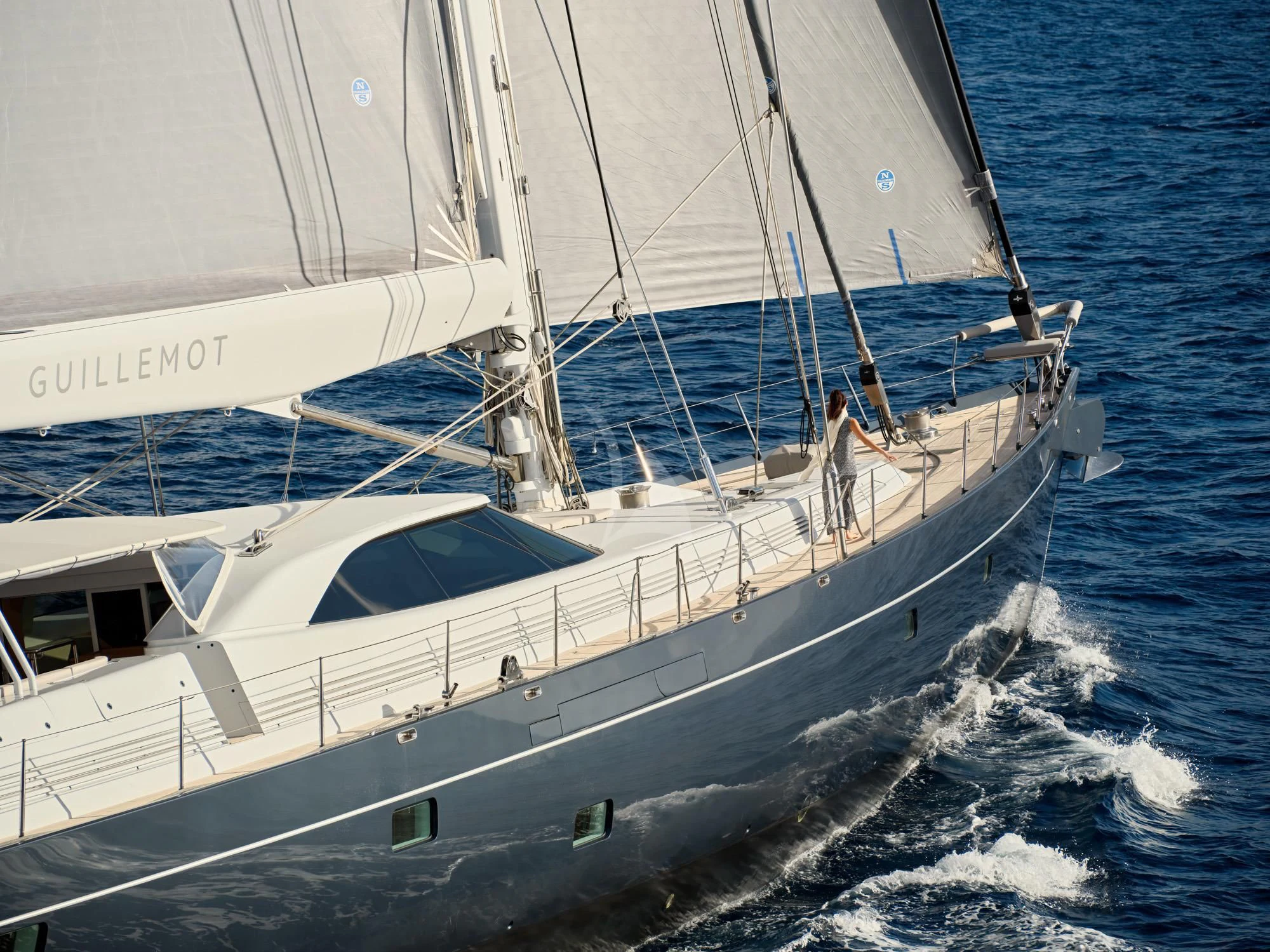 a white boat with a person on it aboard GUILLEMOT Yacht for Sale