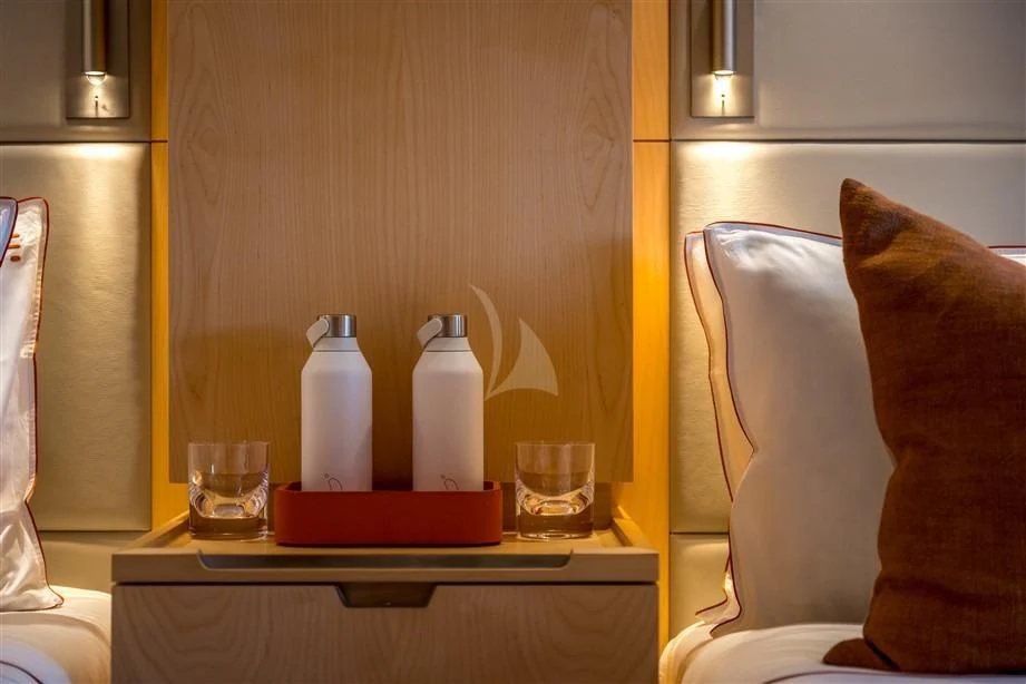 a table with glasses and bottles on it aboard GUILLEMOT Yacht for Sale