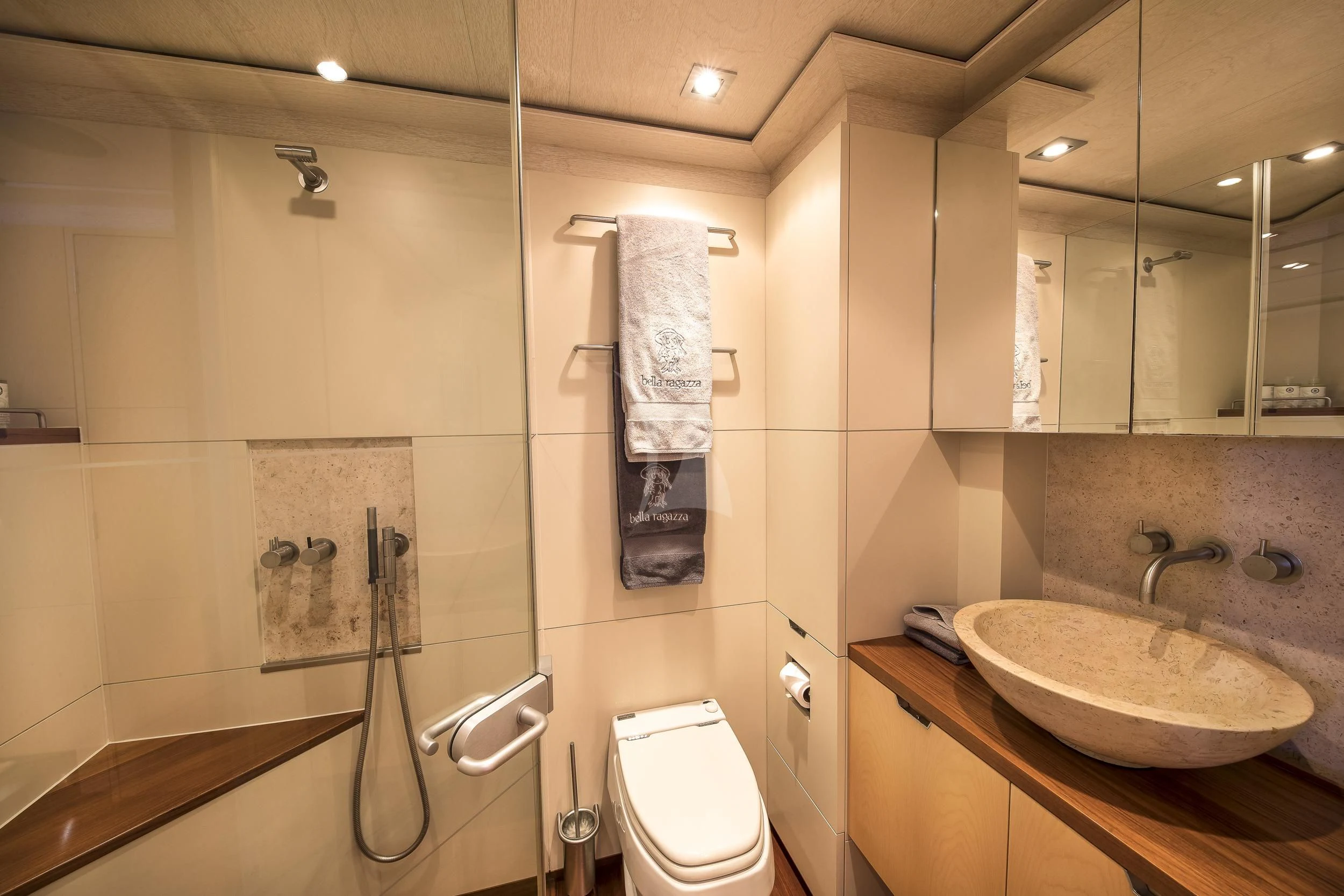 a bathroom with a sink toilet and a mirror aboard GUILLEMOT Yacht for Sale