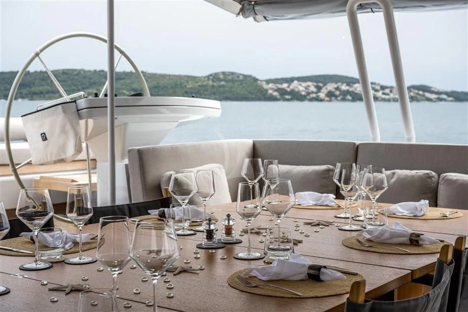 a table set with wine glasses aboard GUILLEMOT Yacht for Sale