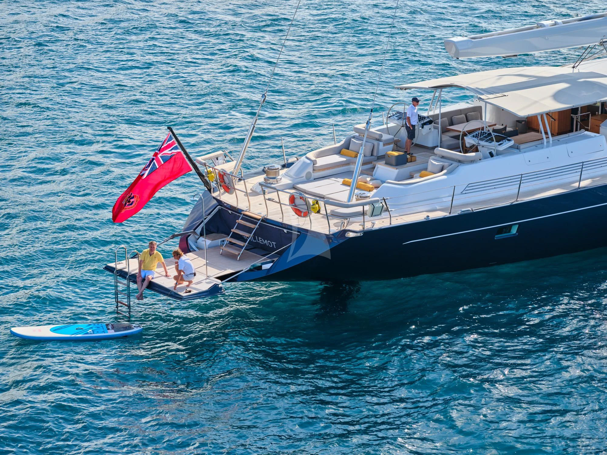 a boat with a flag on it aboard GUILLEMOT Yacht for Sale