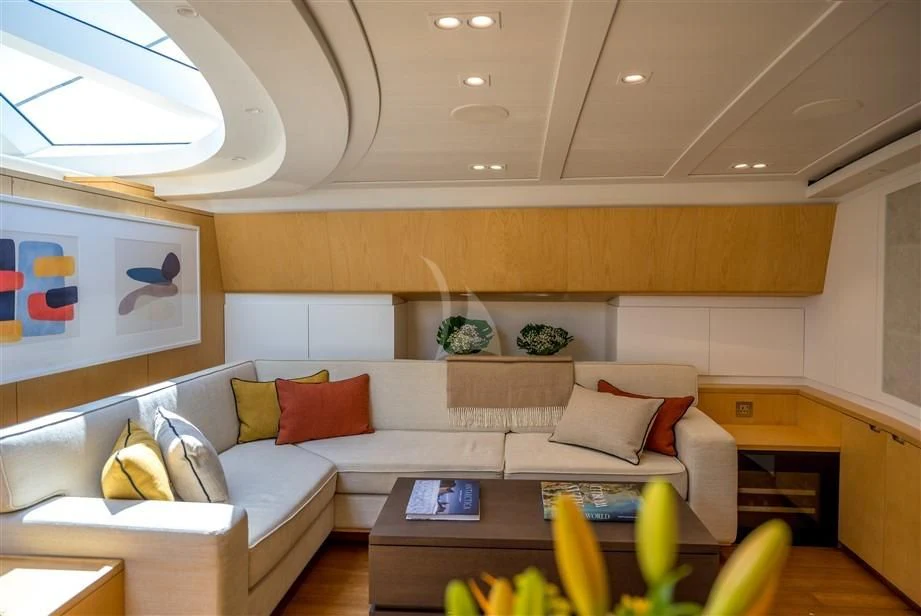 a living room with a white couch aboard GUILLEMOT Yacht for Sale