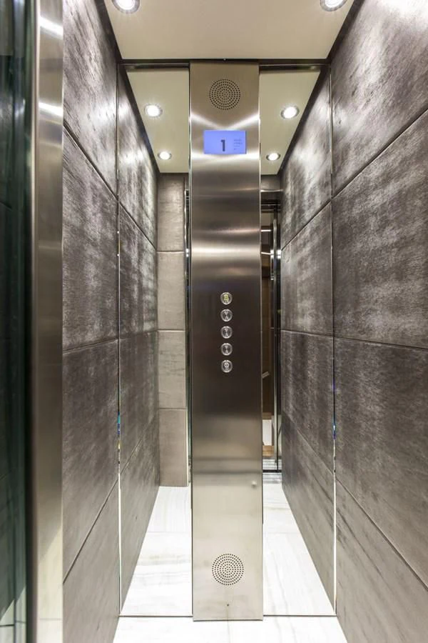 a large elevator with glass doors aboard MAJESTY 155 Yacht for Sale