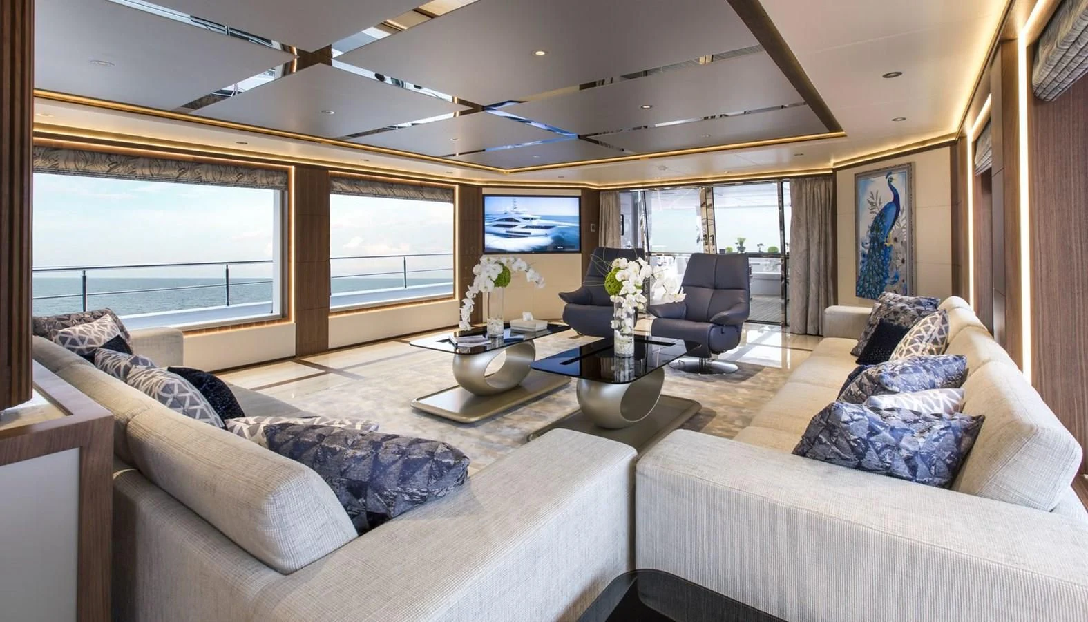 a living room with couches and a table aboard MAJESTY 155 Yacht for Sale