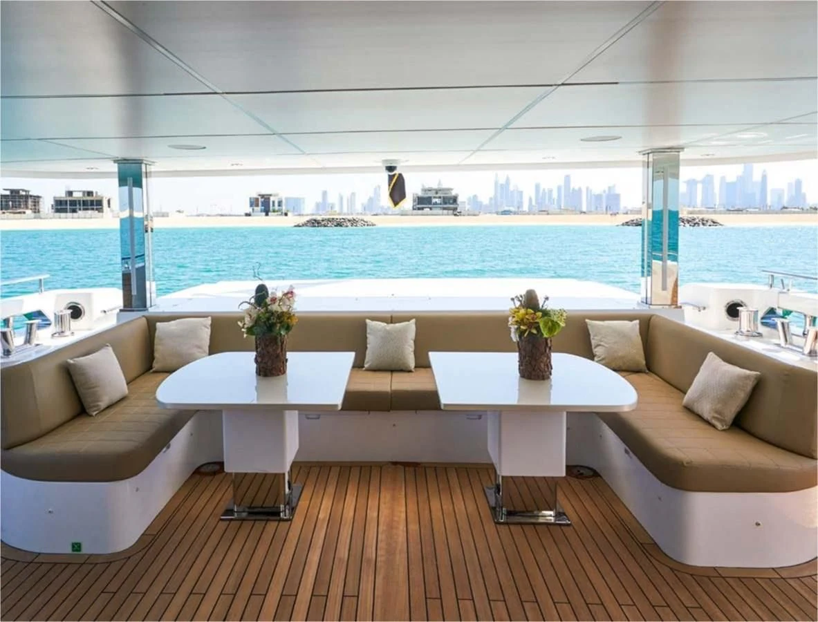 a room with a couch and a table with plants on it aboard MAJESTY 155 Yacht for Sale