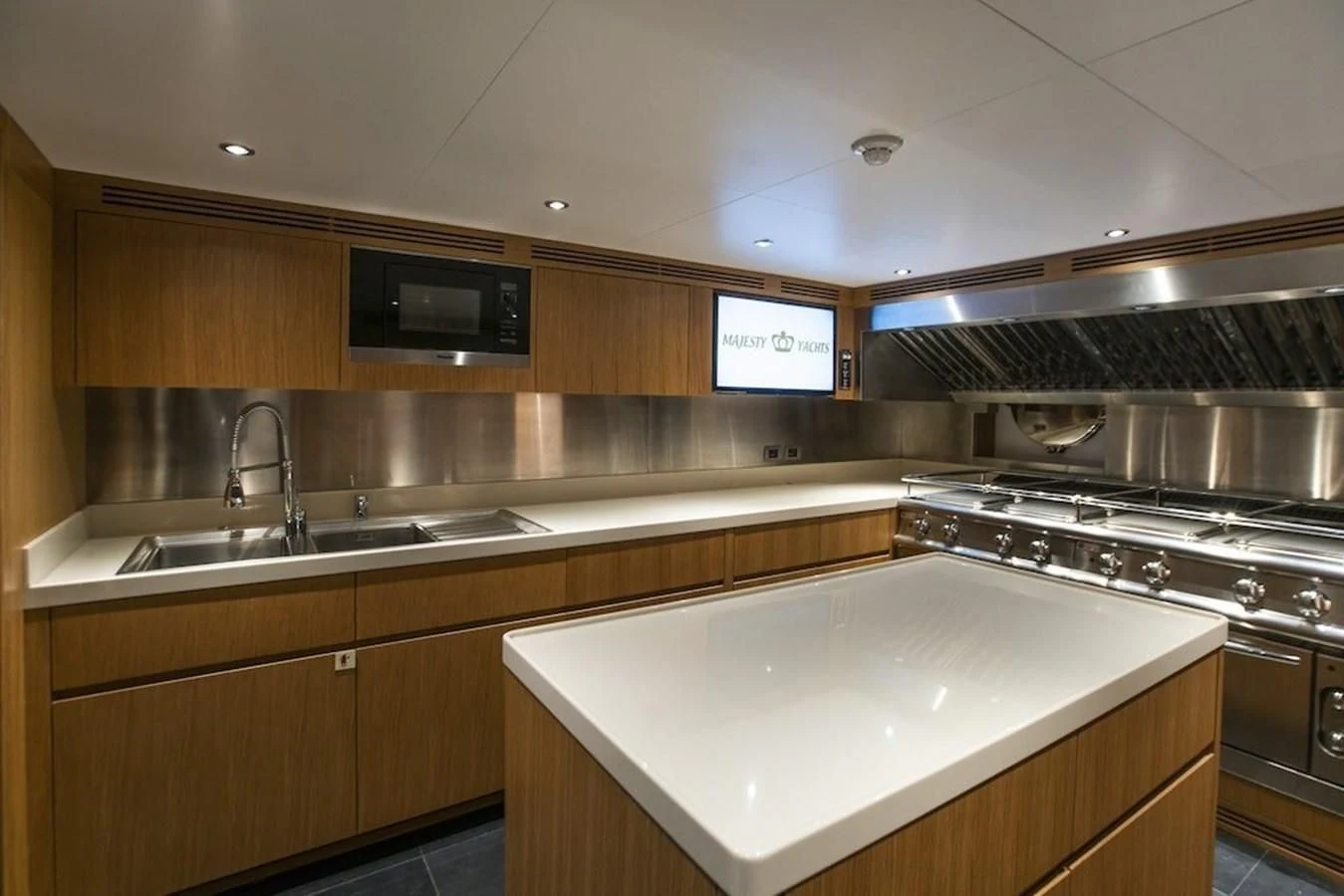 a kitchen with a large island aboard MAJESTY 155 Yacht for Sale
