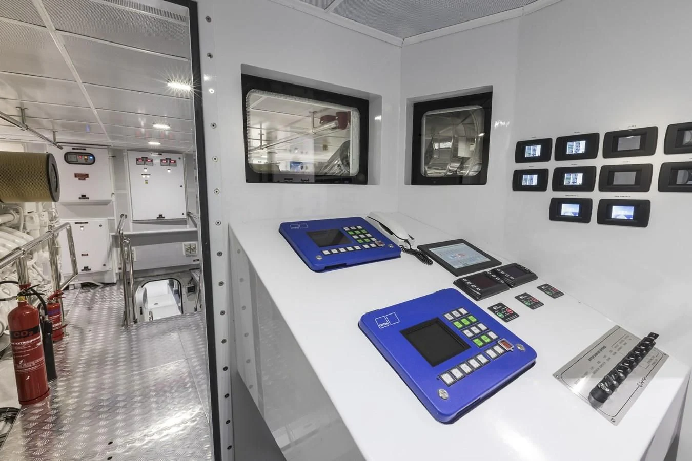 a room with a table and laptops on it aboard MAJESTY 155 Yacht for Sale