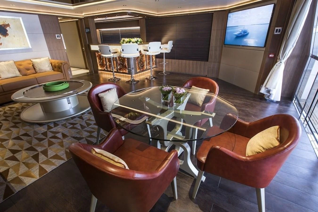 a living room with a table and chairs aboard MAJESTY 155 Yacht for Sale