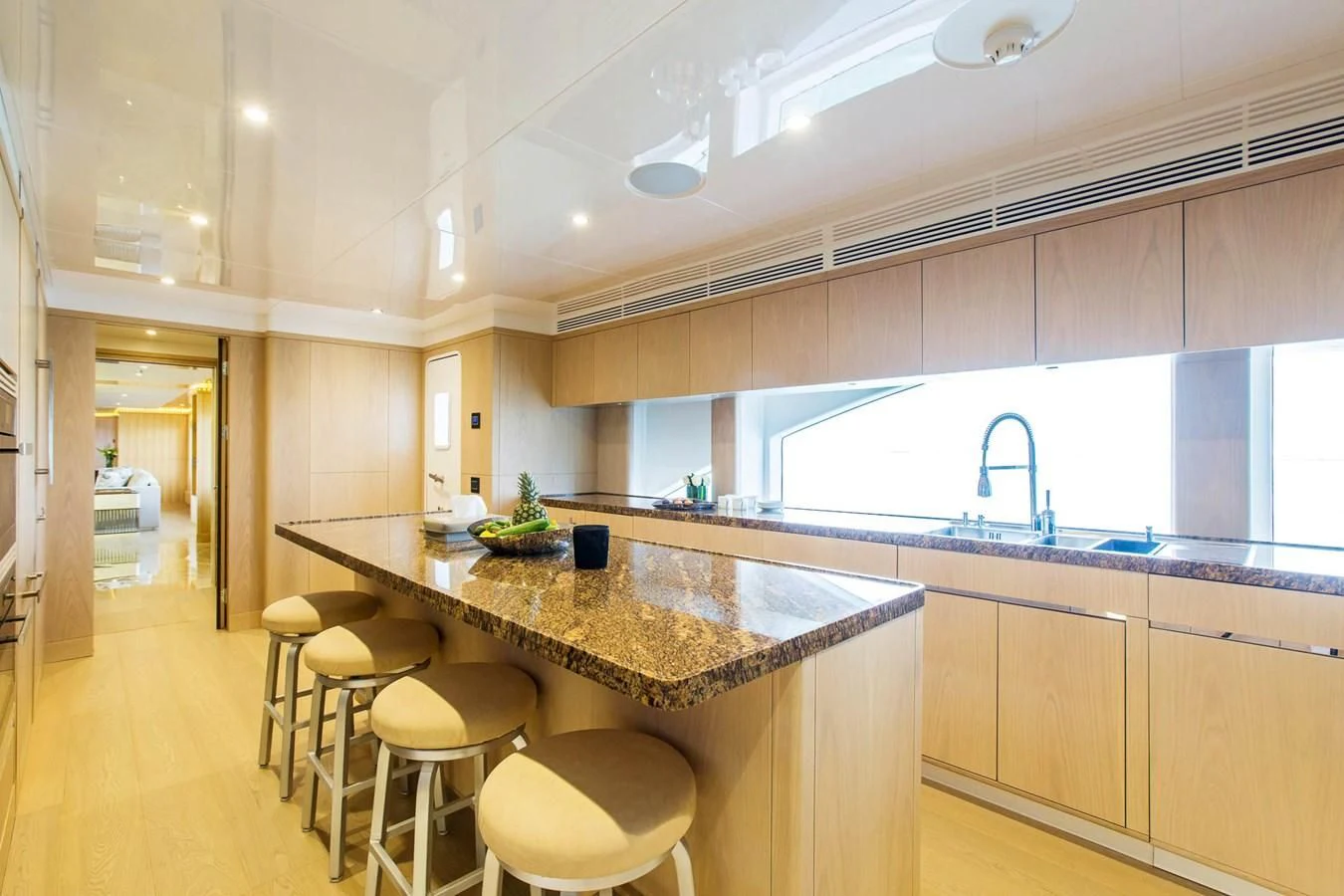 a kitchen with a bar and stools aboard MAJESTY 155 Yacht for Sale