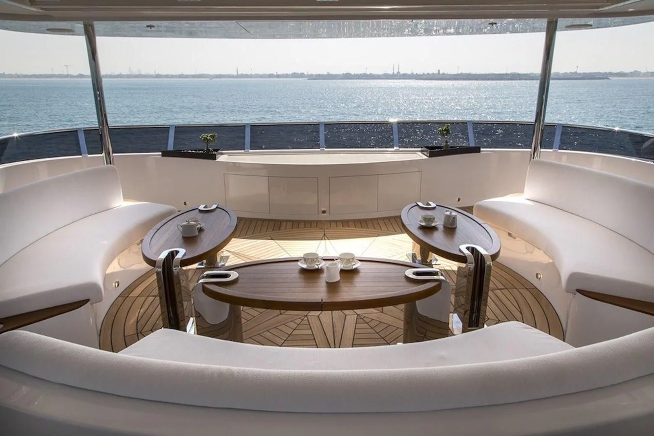 a table and chairs on a balcony aboard MAJESTY 155 Yacht for Sale