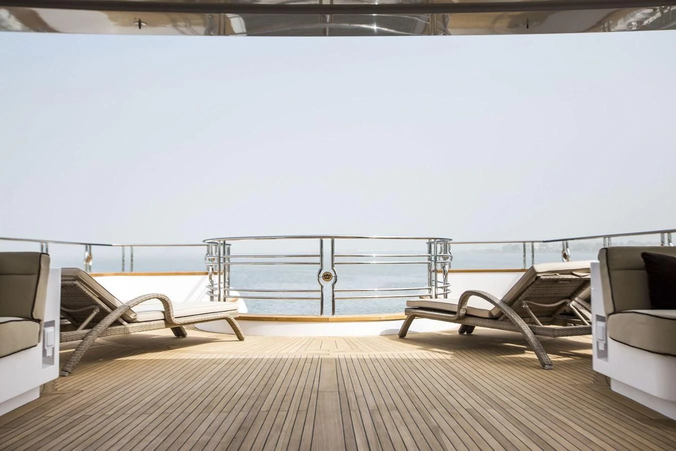 a deck with a chair and a table on it aboard MAJESTY 155 Yacht for Sale