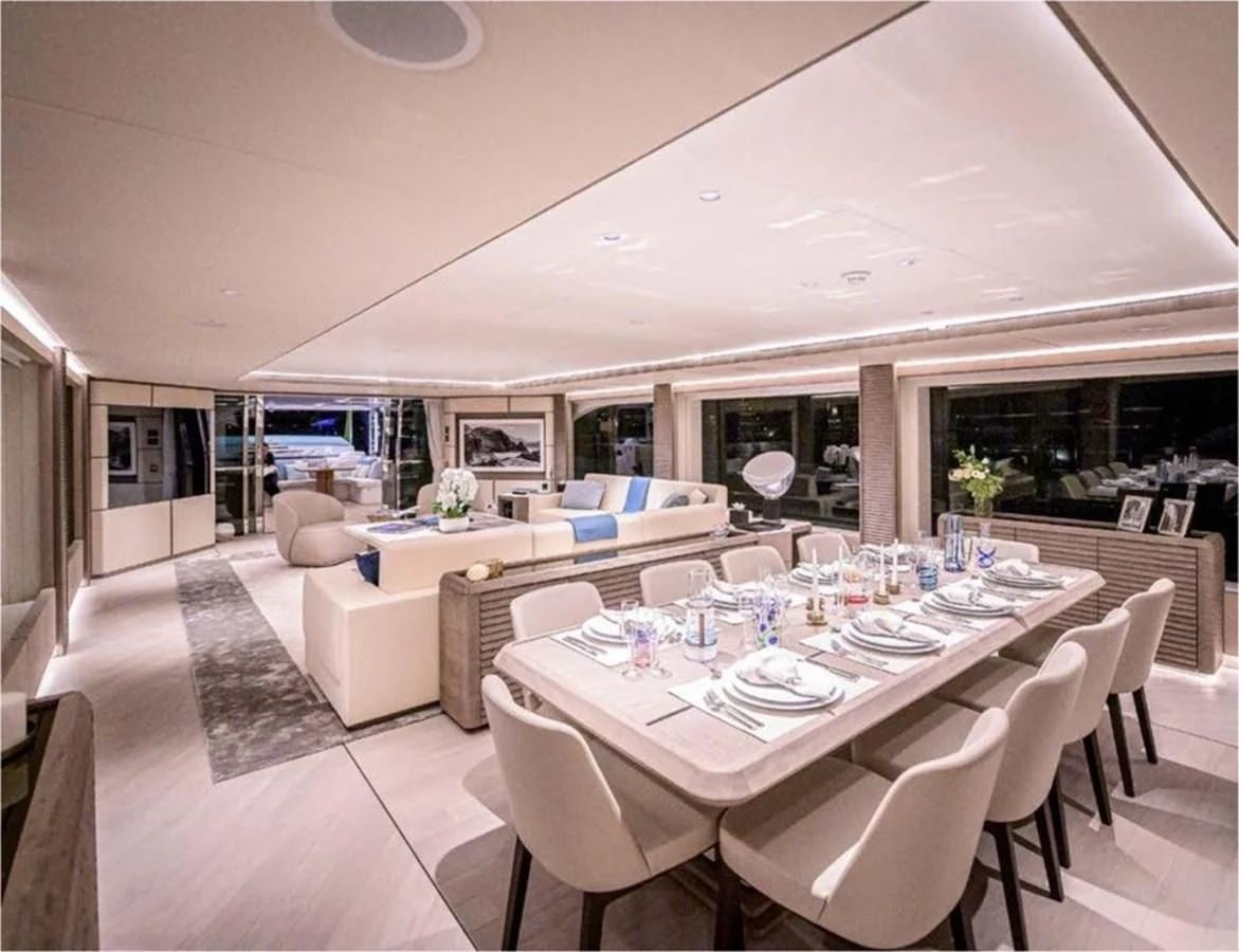a large room with tables and chairs aboard MAJESTY 155 Yacht for Sale